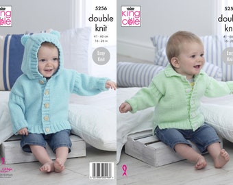 May include: Two knitted baby sweaters, one light blue with a hood and bear ears, and one light green with a collar. Both sweaters have button closures and are sized for 16-20 inches. The pattern is called "double knit" and is easy to knit.