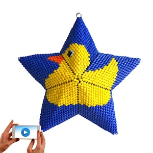 May include: A blue star-shaped ornament with a yellow rubber ducky design. The ornament is made of beads and has a loop at the top for hanging.