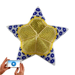 May include: A yellow and blue beaded star ornament with a white center. The star is made of small beads and has a 3D effect.