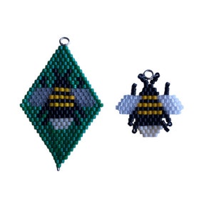 May include: Two beaded bumble bee charms, one is a green diamond shape with a bee in the center, the other is a smaller bee charm.
