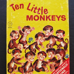 May include: Vintage children's book titled "Ten Little Monkeys" with a yellow cover. The cover features illustrations of ten cartoon monkeys in various poses. The book is published by Rand McNally and is marked as an "Educational Sound" book.