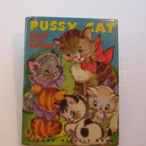 May include: A vintage children's book titled "Pussy Cat Talks to Her Kittens". The cover features a cartoon illustration of a mother cat and four kittens with colorful bows. The book is a Rand McNally publication.