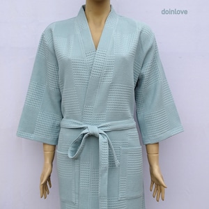 May include: A light blue waffle weave robe with a self-tie belt and two pockets.