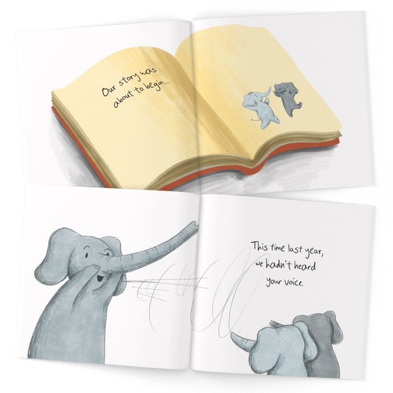 May include: An open book with a yellow cover and red spine. The book is open to a page with the text "Our story was about to begin..." and a drawing of two elephants dancing. The next page has the text "This time last year, we hadn't heard your voice." and a drawing of two elephants with one elephant's trunk curled around the other elephant's trunk.