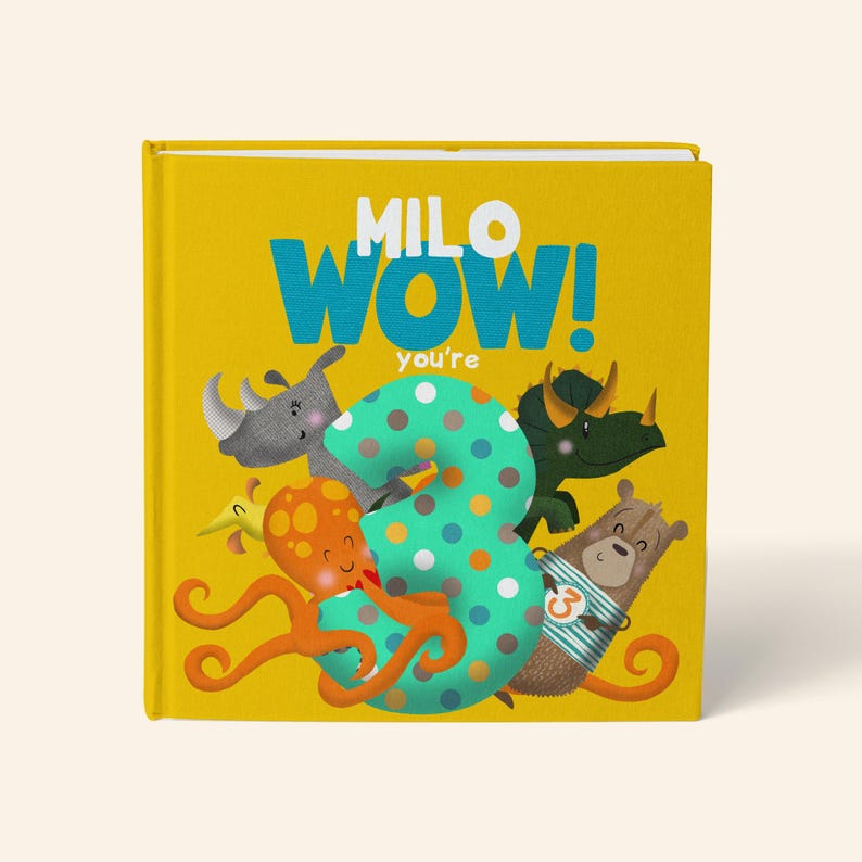 May include: A yellow children's book with the text "MILO WOW! you're" in blue and white. The cover features a large number 3 with polka dots, surrounded by cartoon animals including an octopus, rhino, and bear.