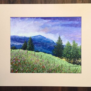 May include: A painting depicting a mountainous landscape with a field of wildflowers in the foreground. The sky is a soft purple and blue, with clouds. There are several trees in the middle ground, and the mountains are in the background.