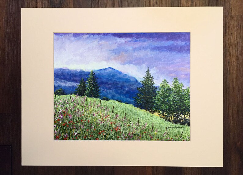 May include: A painting depicting a mountainous landscape with a field of wildflowers in the foreground. The sky is a soft purple and blue, with clouds. There are several trees in the middle ground, and the mountains are in the background.