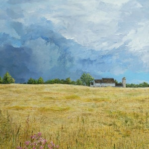 May include: A painting of a white farmhouse with a silo in a field of golden wheat. The sky is a stormy blue with white clouds.