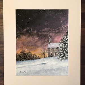 May include: A painting of a stone house with a red door and lit windows, set against a snowy landscape with a dark purple and pink sky. The house is surrounded by trees and snow-covered ground. The sky is filled with stars and a few snowflakes are falling.