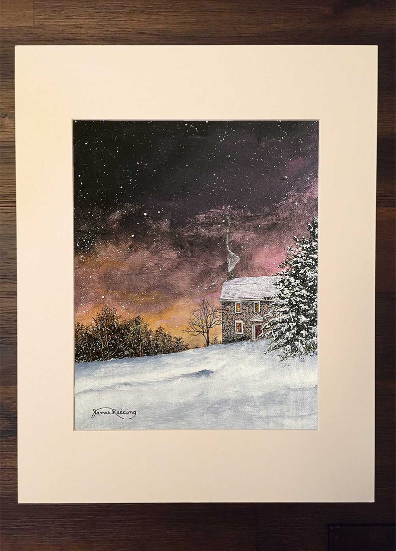 May include: A painting of a stone house with a red door and lit windows, set against a snowy landscape with a dark purple and pink sky. The house is surrounded by trees and snow-covered ground. The sky is filled with stars and a few snowflakes are falling.