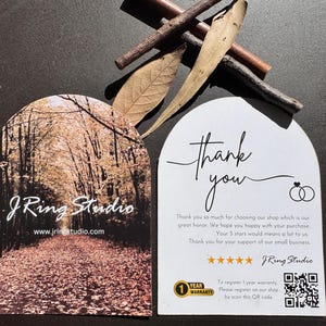 a pair of business cards for a company called J Ring Studio, with a forest scene on one card and a note of thanks on the other.