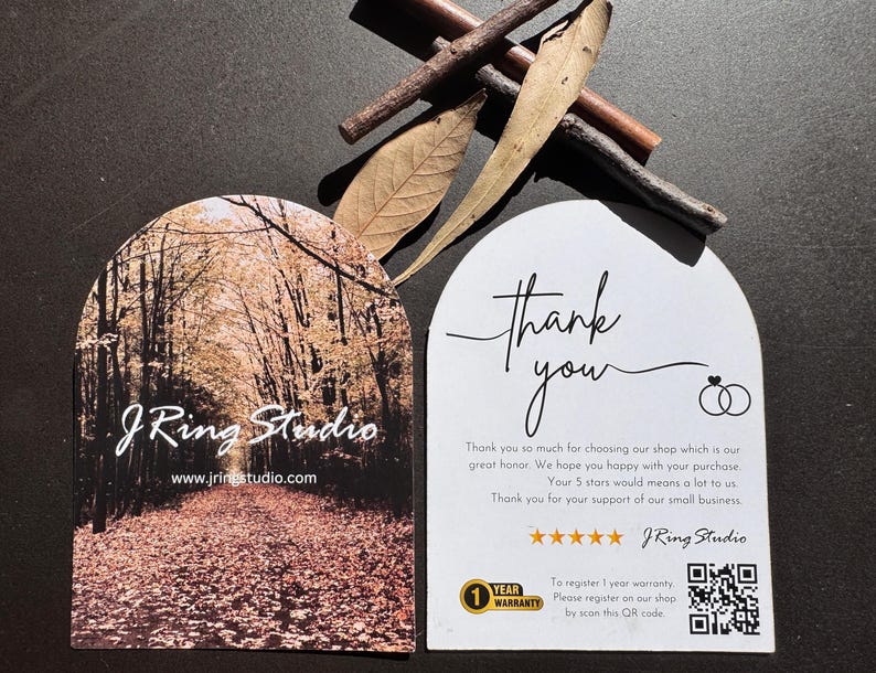 a pair of business cards for a company called J Ring Studio, with a forest scene on one card and a note of thanks on the other.