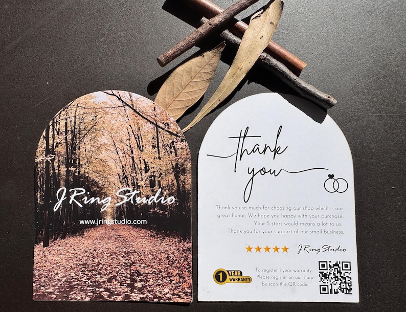 a pair of business cards for a company called J Ring Studio, with a forest scene on one card and a note of thanks on the other.