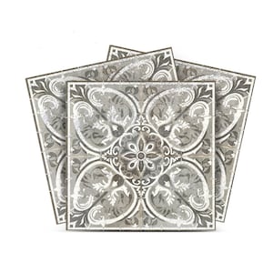 Könnte beinhalten: Drei graue und weiße Keramikfliesen mit einem floralen Muster. Die Fliesen haben einen abgenutzten Look und sind in einem Stapel angeordnet.