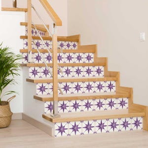 May include: Purple and white star-shaped tile decals on wooden stairs. The decals are arranged in a repeating pattern.