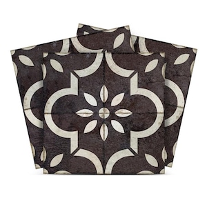 May include: Three black and white patterned floor tiles with a geometric design. The tiles have a distressed look and are arranged in a stack.
