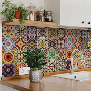 May include: A colorful kitchen backsplash with a mosaic tile pattern. The tiles are in shades of red, blue, yellow, and green. A small plant in a white mug with the text "Good Morning Have a Happy Coffee" is in the foreground.