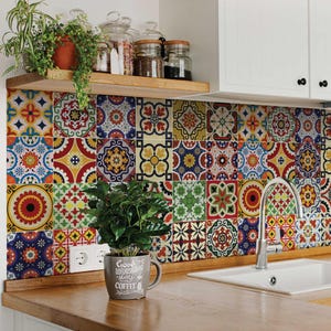 May include: A colourful kitchen backsplash with a mosaic tile pattern. The tiles are in shades of red, blue, yellow, and green. A small plant in a white mug with the text "Good Morning Have a Happy Coffee" is in the foreground.