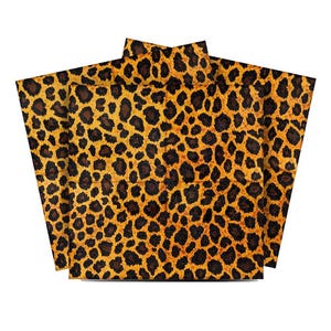 May include: A set of three leopard print napkins. The napkins are made of a soft, absorbent material and are perfect for everyday use.