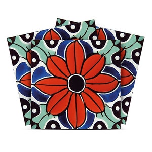 May include: Three ceramic tile coasters with a colorful floral design. The coasters feature a large red flower with a black center surrounded by blue, green, and white geometric patterns.