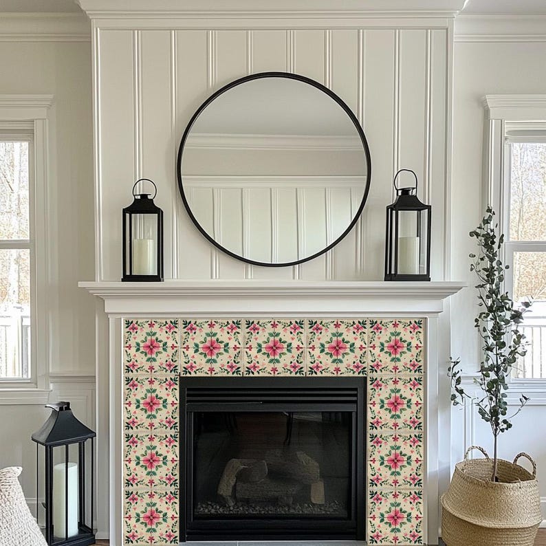 May include: A white fireplace mantel with a black mirror and two black lanterns. The fireplace has a black surround and a black firebox. The fireplace is decorated with pink and green floral tile.