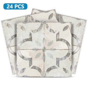 Peut inclure: Un paquet de 24 autocollants de carrelage à coller. Les autocollants présentent un fond blanc avec un motif floral gris et bleu.