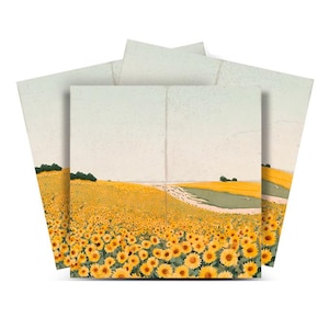 May include: A set of square art prints featuring a field of sunflowers under a pale sky. The artwork depicts a path winding through the vibrant yellow flowers, with green trees and fields in the distance. The prints have a vintage, textured appearance.