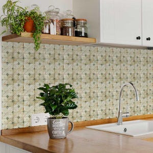 May include: A kitchen scene featuring a wooden countertop, a white sink, and a stainless steel faucet. The backsplash is tiled with a square pattern in shades of beige and green. A potted plant sits on the counter, and a shelf above holds jars and plants.