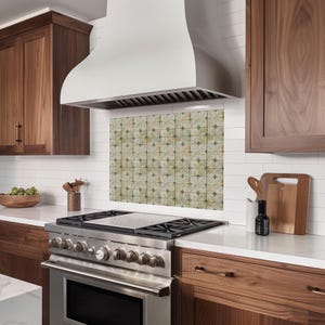 May include: A modern kitchen featuring a stainless steel range with a white range hood. The backsplash is tiled with a repeating geometric pattern. Dark wood cabinets and white countertops complete the design.