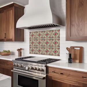 May include: A stainless steel range hood with a white canopy over a kitchen stove with a floral tile backsplash.