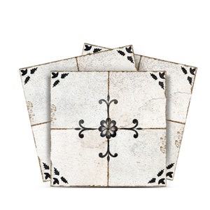 May include: Three white ceramic tiles with a black floral design. The tiles have a distressed, vintage look.