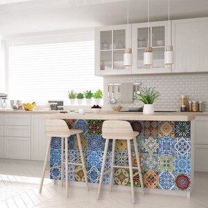 May include: A white kitchen island with a wood countertop and a backsplash of colorful patterned tiles. Two wooden bar stools are positioned in front of the island.
