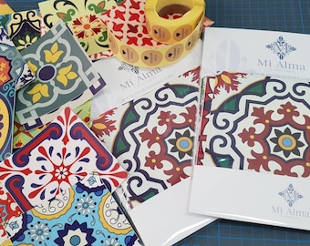 May include: A set of colorful patterned tile stickers with a roll of adhesive tape and a thank you card. The tile stickers feature a variety of geometric designs in shades of red, blue, yellow, green, and white. The card has the text "Mi Alma" and "Thank You" printed on it.