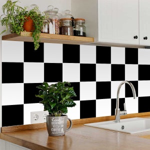 May include: Black and white chequered kitchen tile backsplash with a small potted plant and a coffee mug that says "Good Morning starts with Coffee".