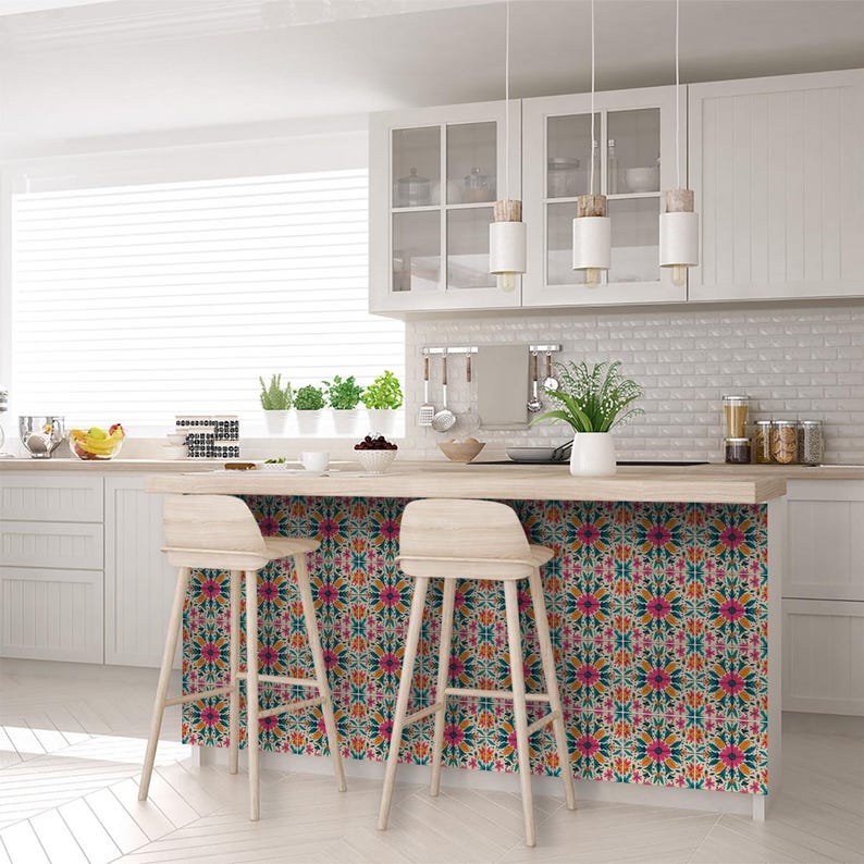 May include: A kitchen island with a wood countertop and two bar stools. The backsplash is covered in colorful patterned tile.
