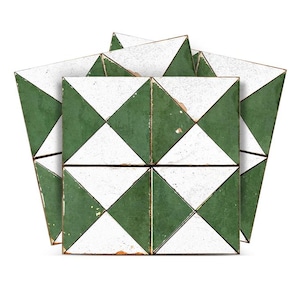 May include: A collection of square tiles with a geometric pattern. Each tile features a white and green diamond design. The tiles are arranged in a fan-like shape, showcasing their pattern and colour scheme. The tiles have a slightly distressed appearance.