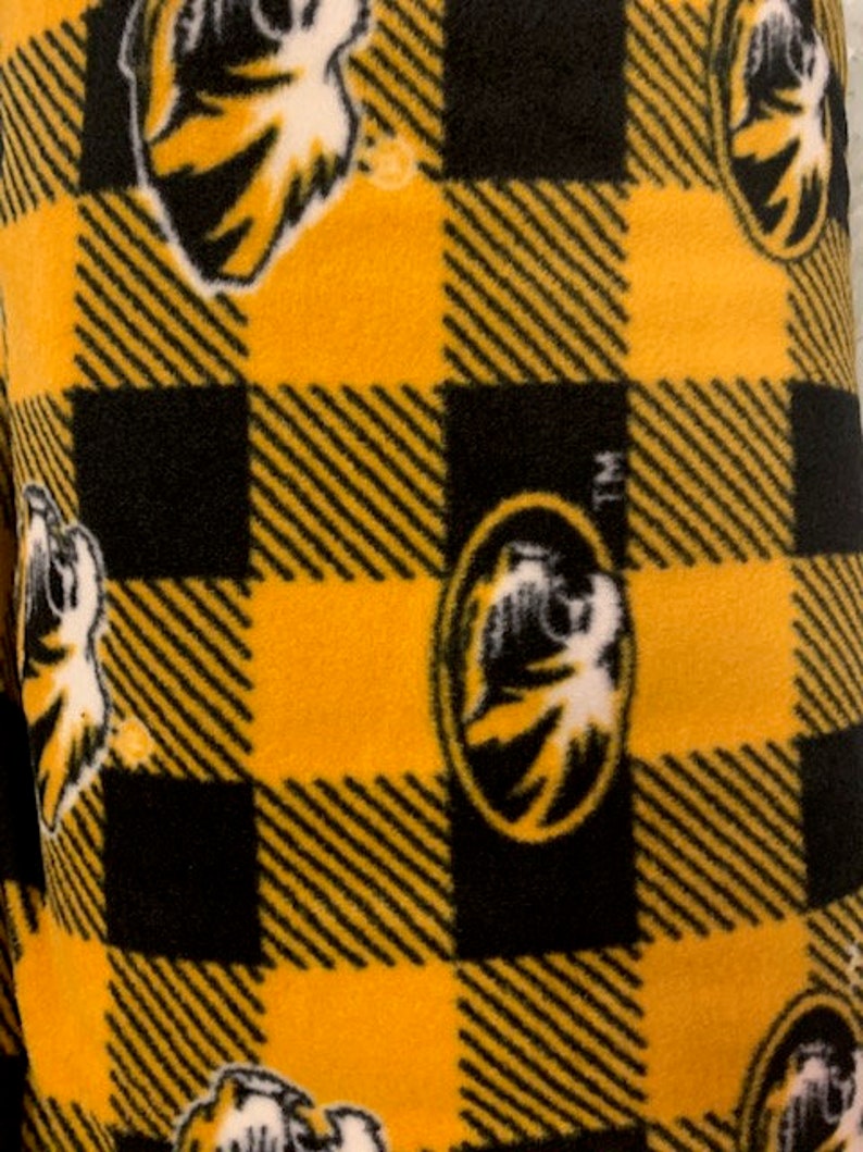 May include: Black and gold checked fabric with a repeated pattern of a tiger head logo.