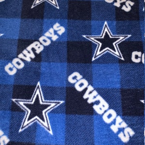 May include: Blue and black checked fleece blanket with a white "Cowboys" logo and a white five-pointed star with a blue centre.