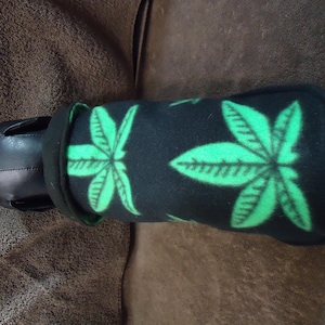 May include: Black fleece dog collar with a green marijuana leaf pattern.