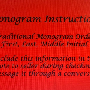 May include: Red background with black text explaining how to order a monogram. The text reads "Monogram Instructions", "Traditional Monogram Order", "First, Last, Middle Initial", "Include this information in the note to seller during checkout or message it through a conversation."