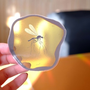 Jurassic Park mosquito in amber vinyl sticker, transparent