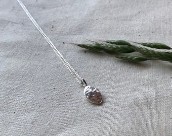 Silver seed necklace in recycled silver, symbolic of new beginnings