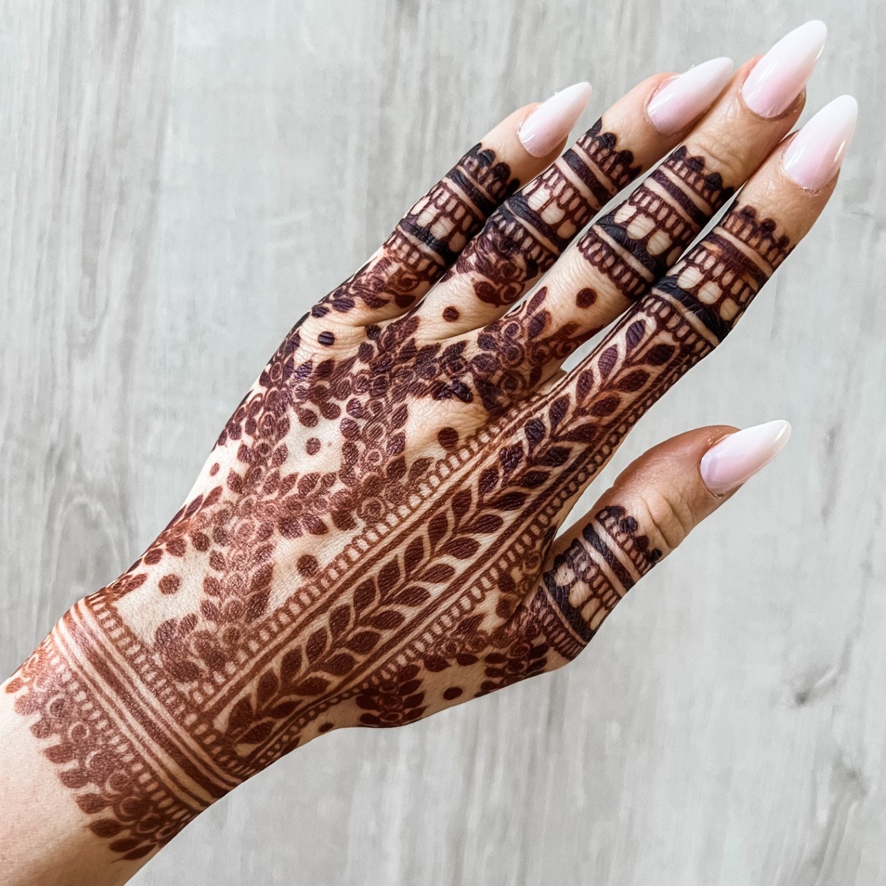 Swooshes and Delicious Dots using a mehndi/henna cone. Credit to