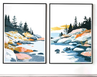 May include: Two framed landscape art prints. Each print features a stylized depiction of a river scene with rocks, trees, and a white sky. The color palette includes blues, oranges, and greens, creating a serene and natural aesthetic.