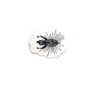 May include: Black and white sticker with a rocket ship design and the text "Blast Off to Tomorrow".