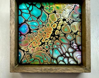 Three acrylic painted tiles set in stained shadow boxes.