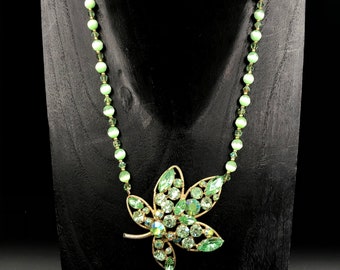 Vintage green rhinestone leaf brooch strung on Swarovski crystals, seed beads and fiber optic glass beads.