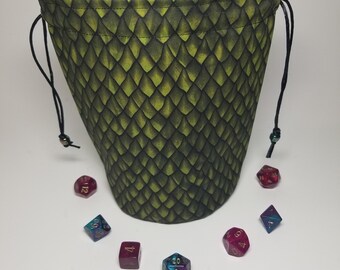 May include: Green dragon scale dice bag with black drawstring and a variety of iridescent dice in red, blue, and purple.