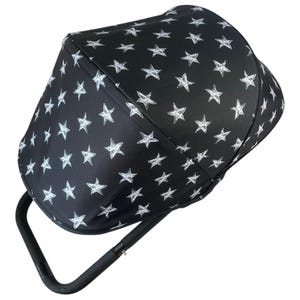May include: Black stroller canopy with a white star pattern. The canopy is folded and has a black metal frame.
