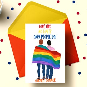 May include: A card with a rainbow flag and two people standing behind it. The text on the card reads "Love has no limits only people do!" and "Garrett Connor".